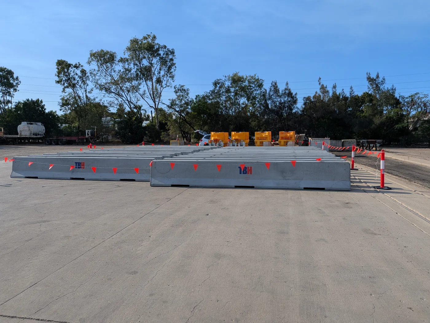 TBH concrete jersey barriers laid out on site with Absorb-M crash cushions in the background