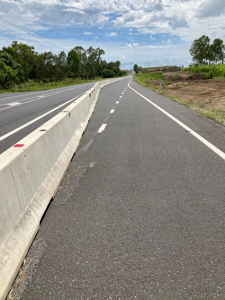 Concrete barrier line separating traffic lanes on a regional road